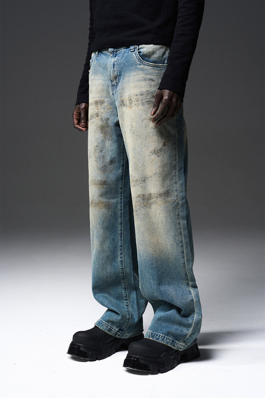 Mud-dyed solid color damaged jeans