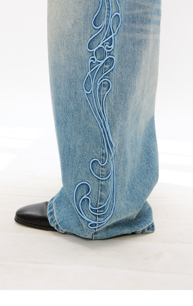 Vintage-style denim pants with totem embroidery
