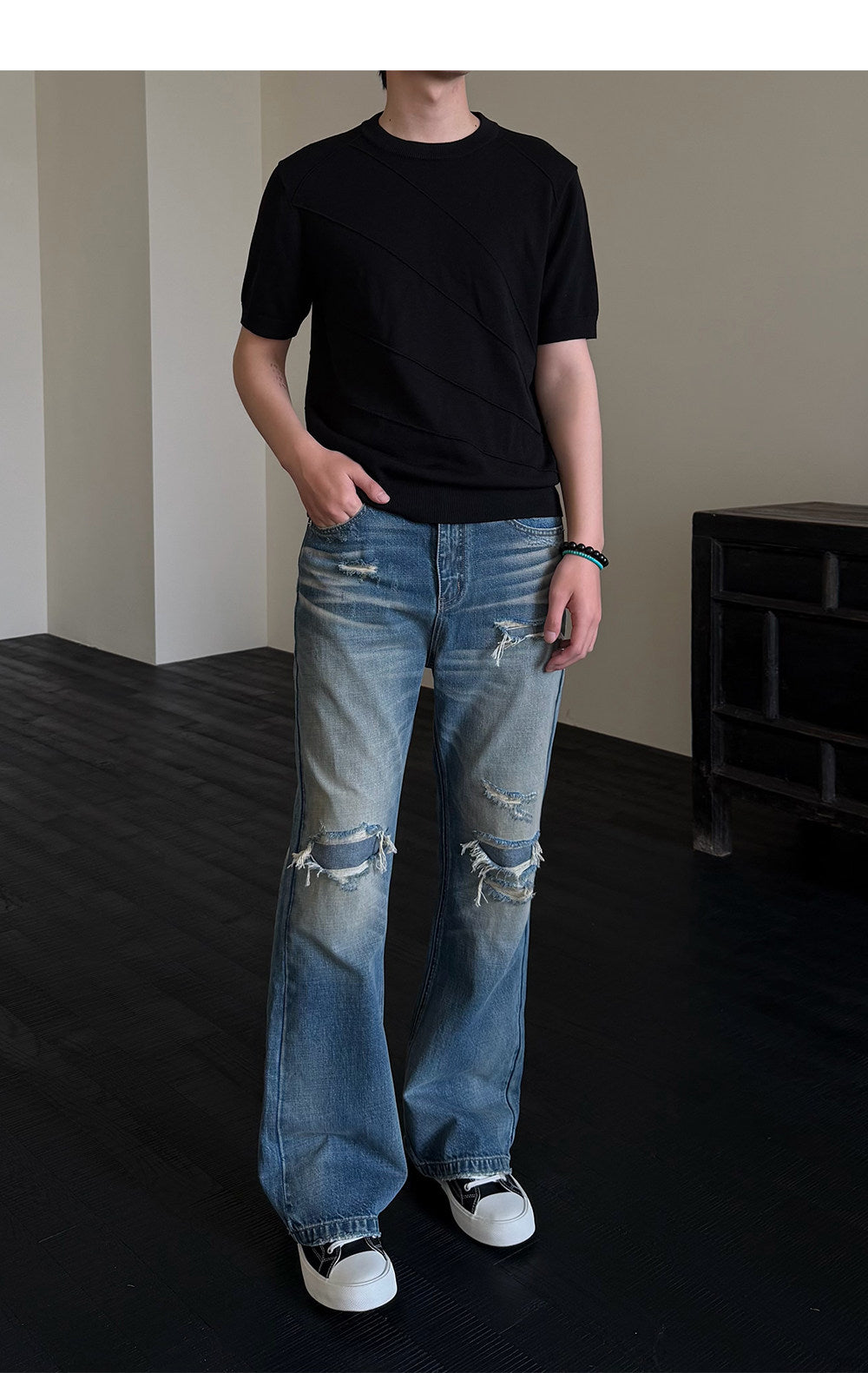 Micro-flared jeans with hole patches and distressed detailing