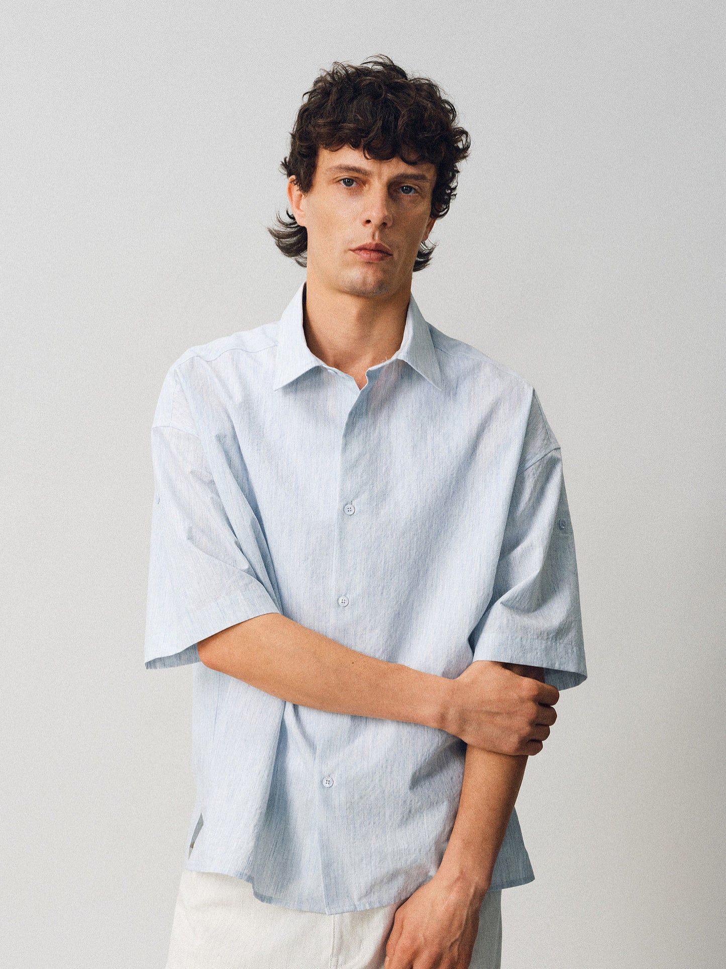 A relaxed-fit shirt with rolled sleeves