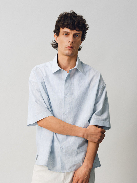 A relaxed-fit shirt with rolled sleeves