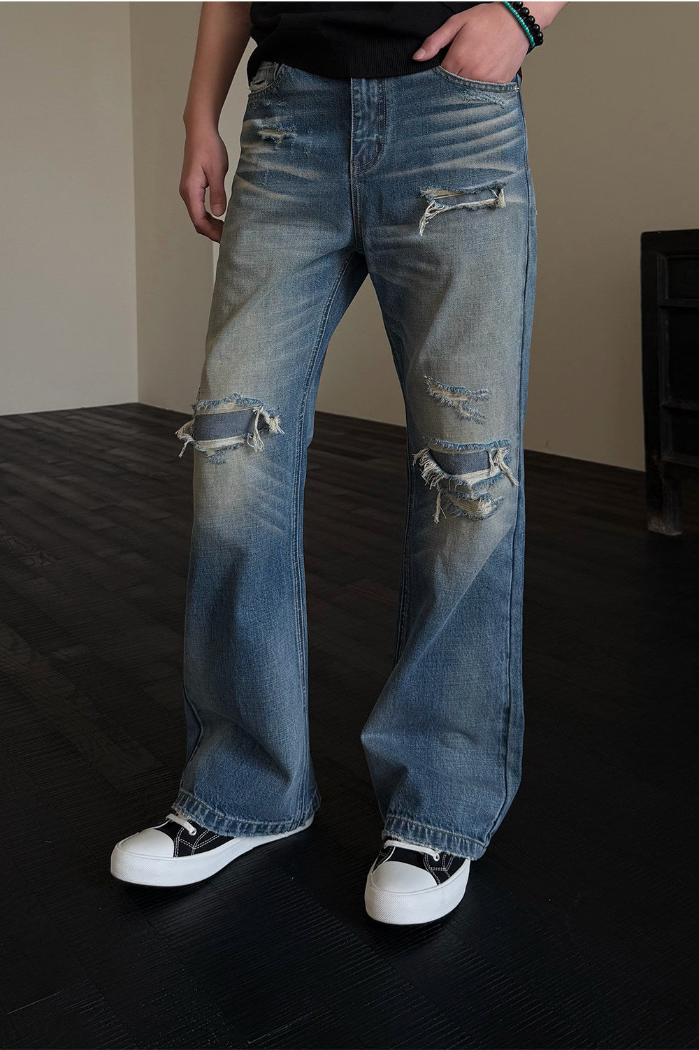 Micro-flared jeans with hole patches and distressed detailing
