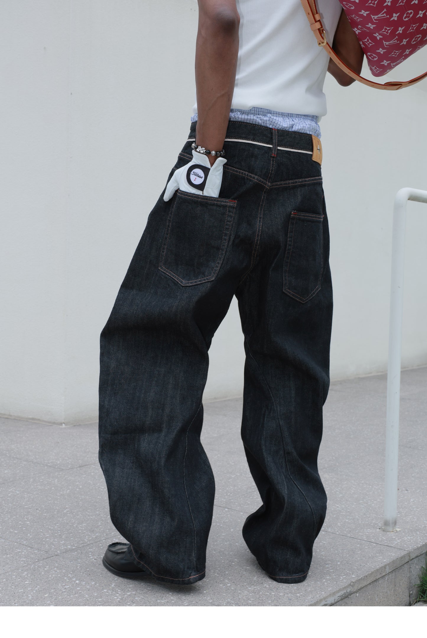 Denim pants with diagonal buckles