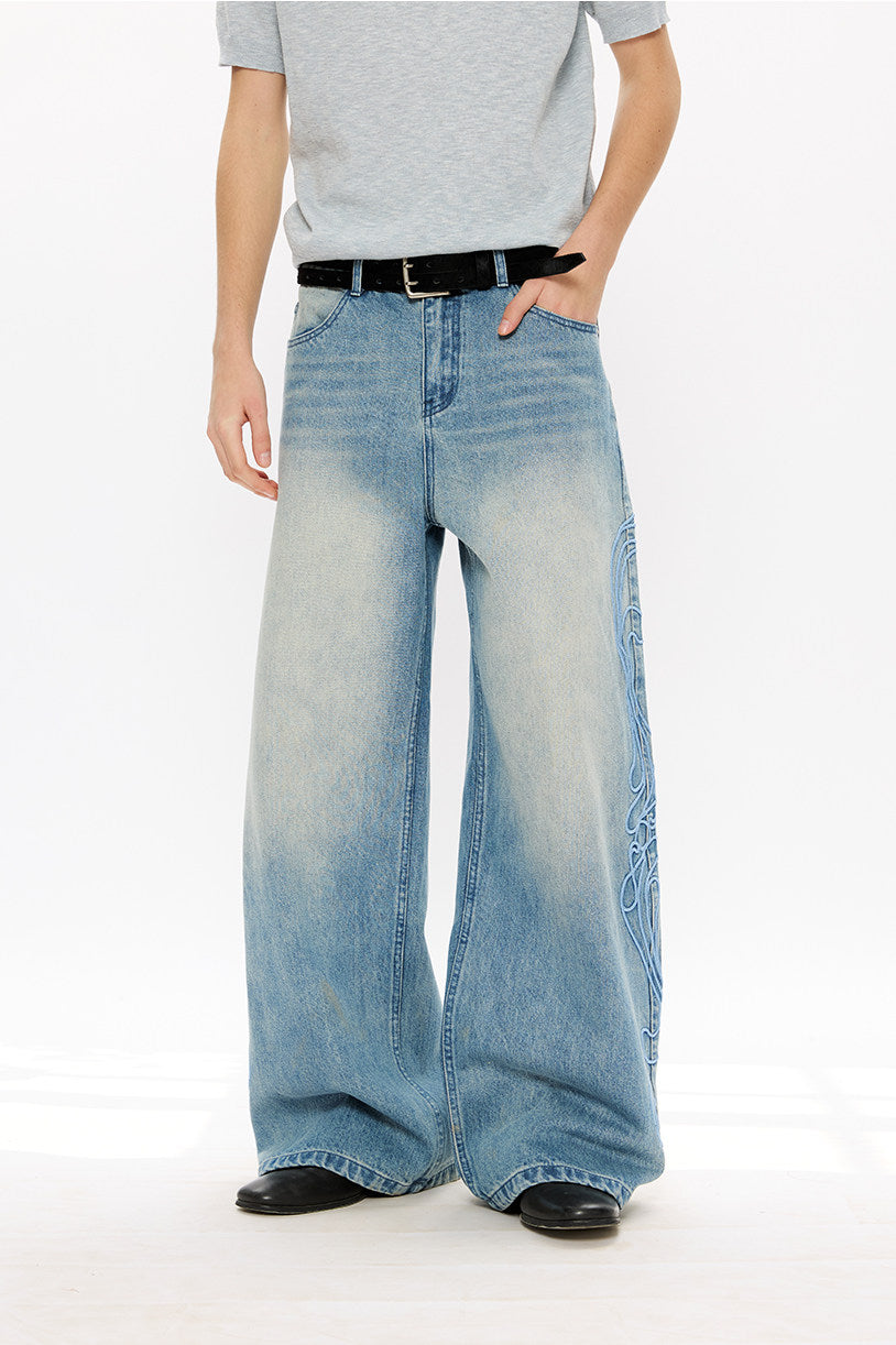 Vintage-style denim pants with totem embroidery