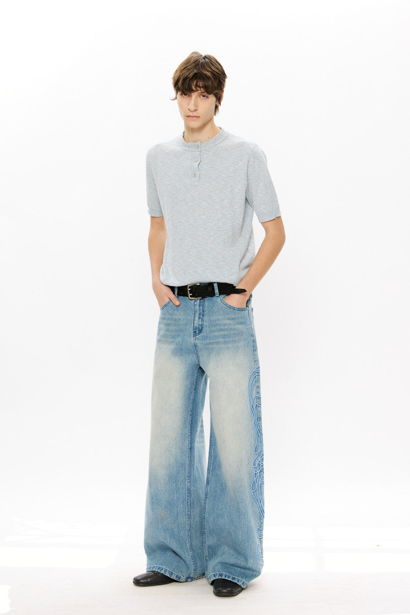 Vintage-style denim pants with totem embroidery