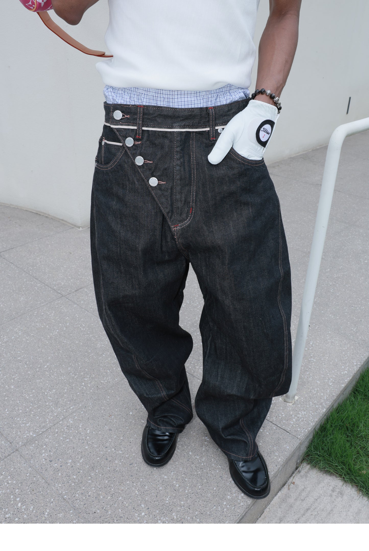 Denim pants with diagonal buckles