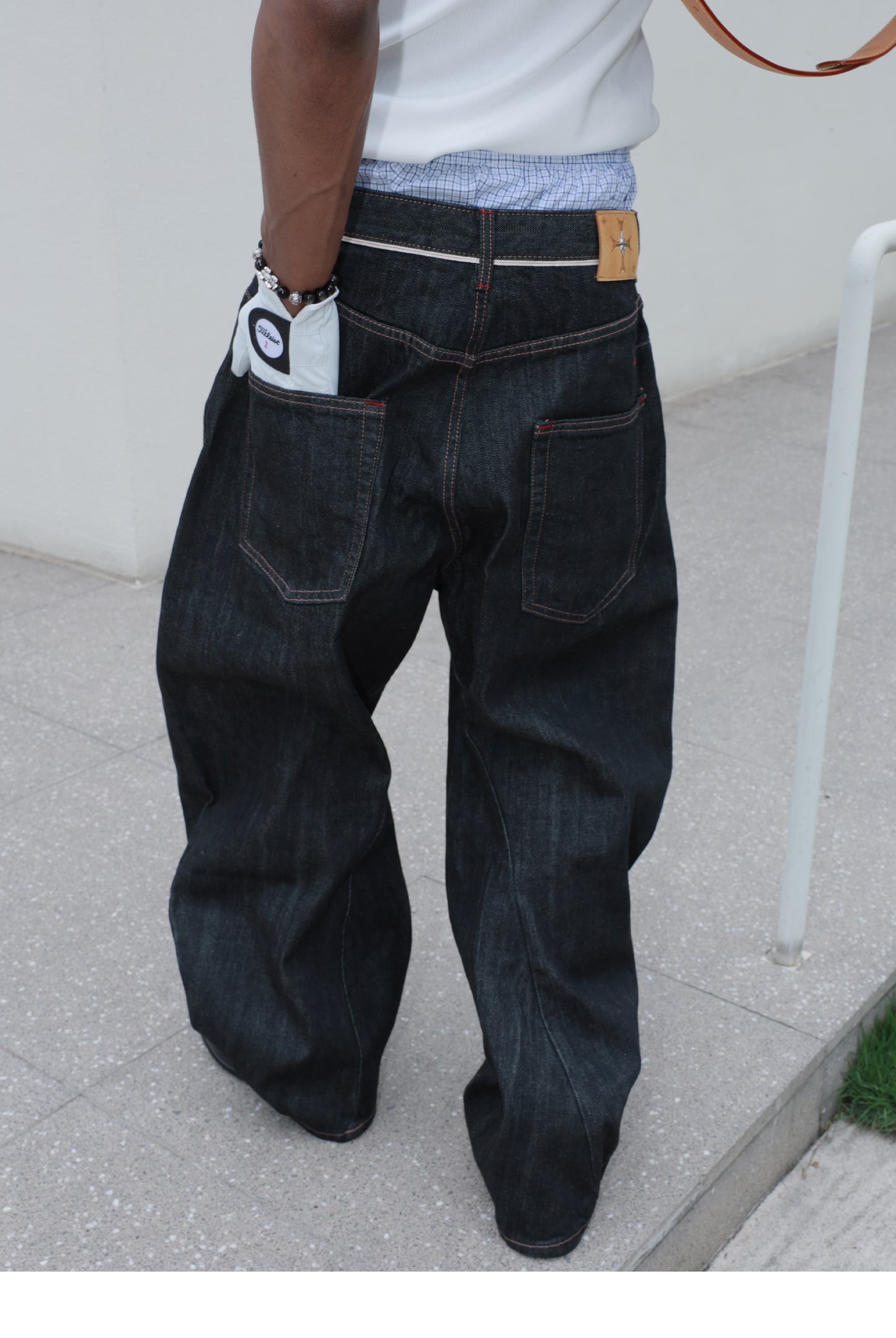 Denim pants with diagonal buckles