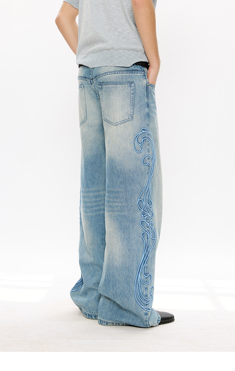Vintage-style denim pants with totem embroidery