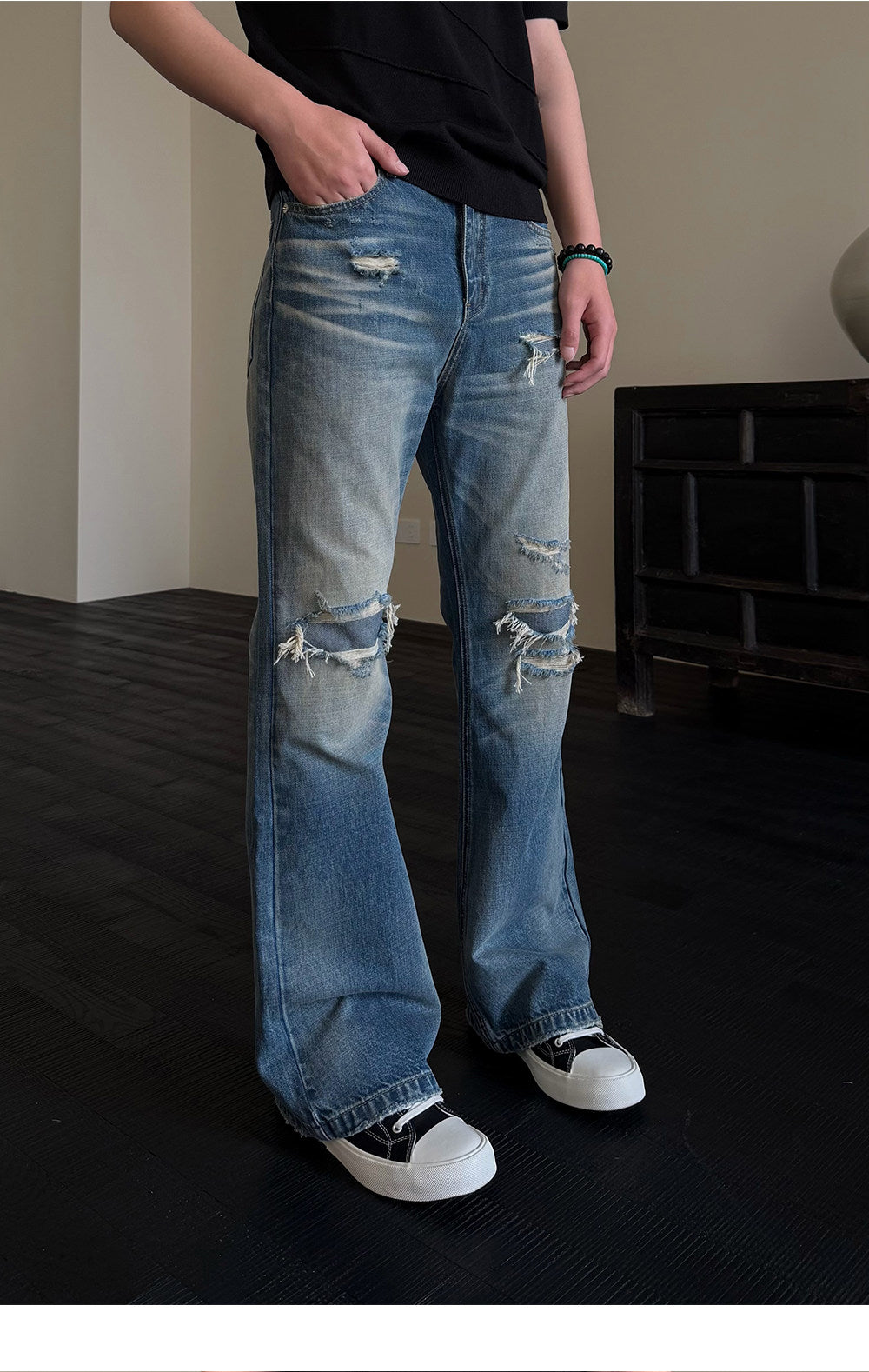 Micro-flared jeans with hole patches and distressed detailing