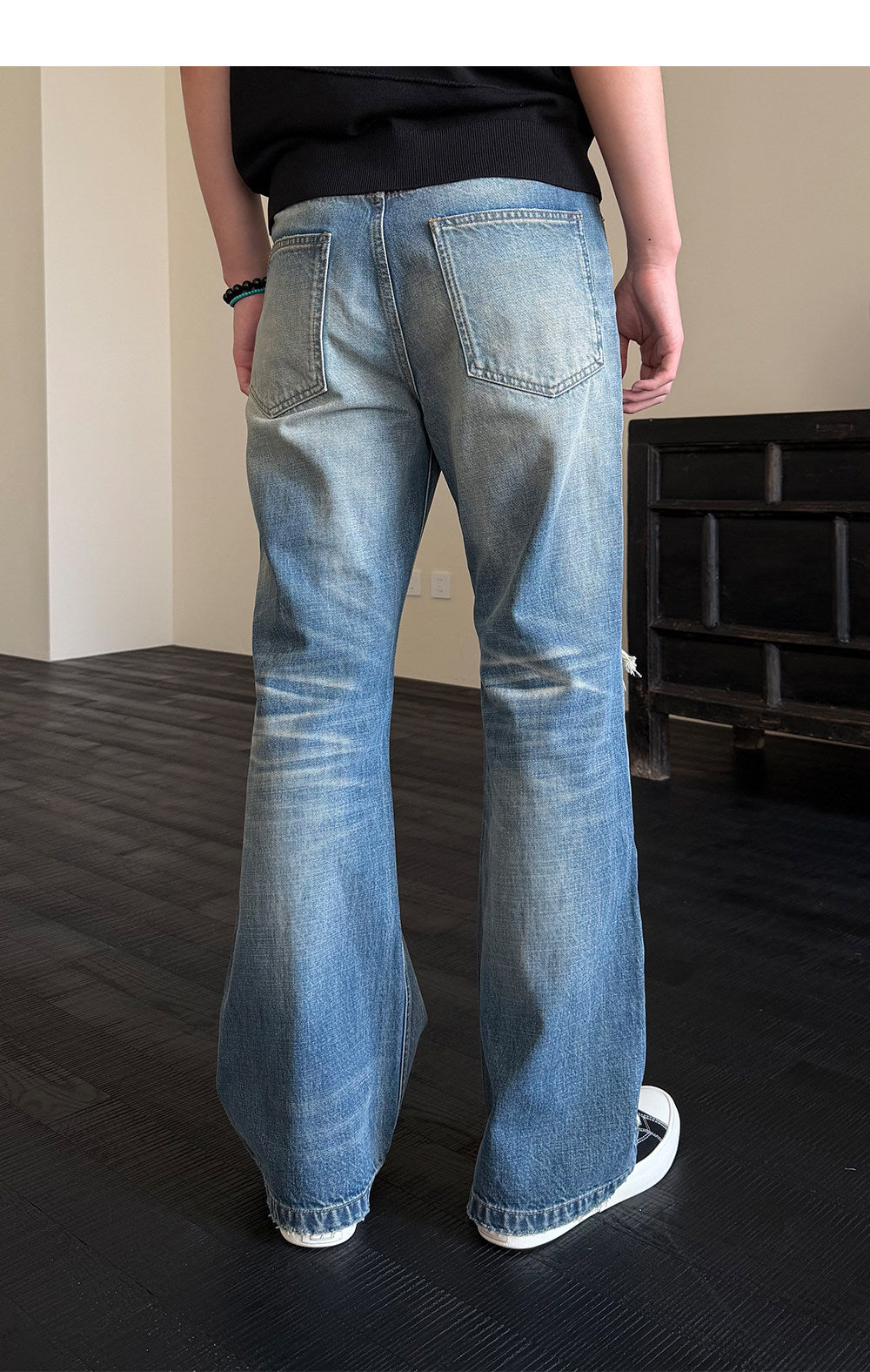 Micro-flared jeans with hole patches and distressed detailing