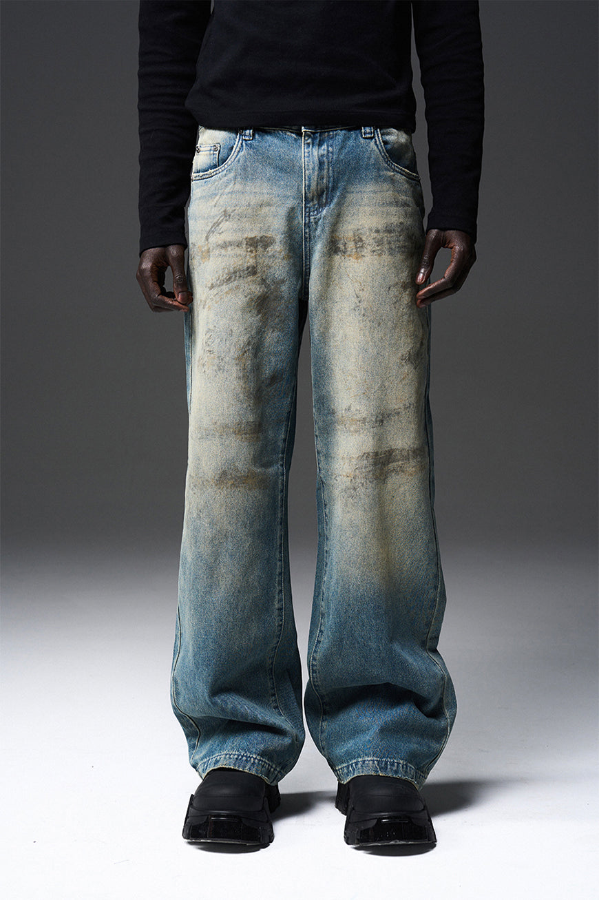 Mud-dyed solid color damaged jeans